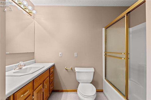 bathroom featuring toilet, vanity, enclosed tub / shower combo, and baseboards