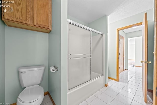 full bathroom featuring tile patterned floors, shower / bath combination with glass door, toilet, and baseboards