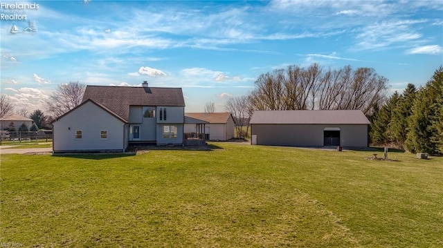 back of property featuring an outbuilding and a yard