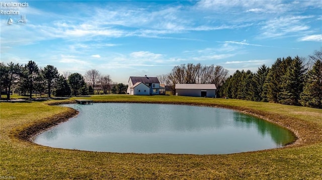 exterior space featuring a lawn and a water view
