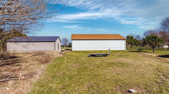 view of yard featuring an outdoor structure and an outbuilding