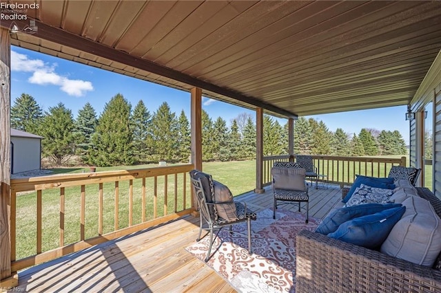 deck with an outdoor hangout area and a lawn
