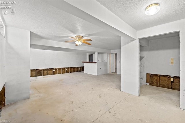 interior space with a ceiling fan and a textured ceiling