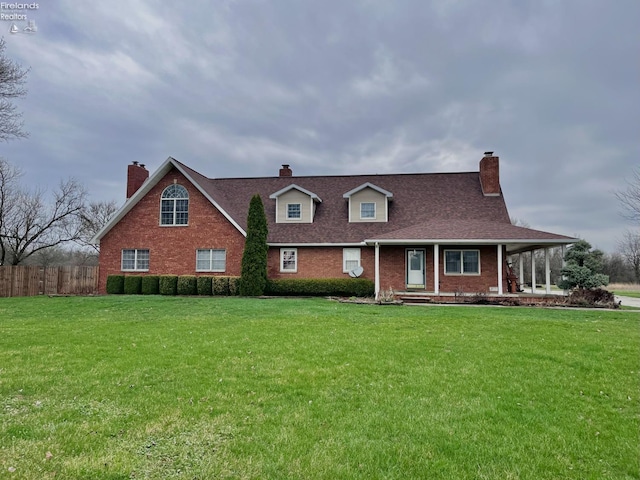 6276 County Road 33, Helena, OH 43435 - new england style home featuring roof with shingles, a front yard, brick siding, and a chimney