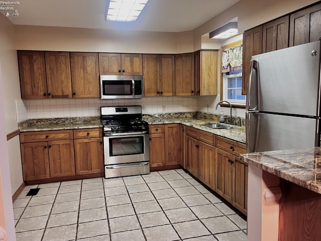 6276 County Road 33, Helena, OH 43435 - kitchen with stone countertops, a sink, backsplash, and appliances with stainless steel finishes