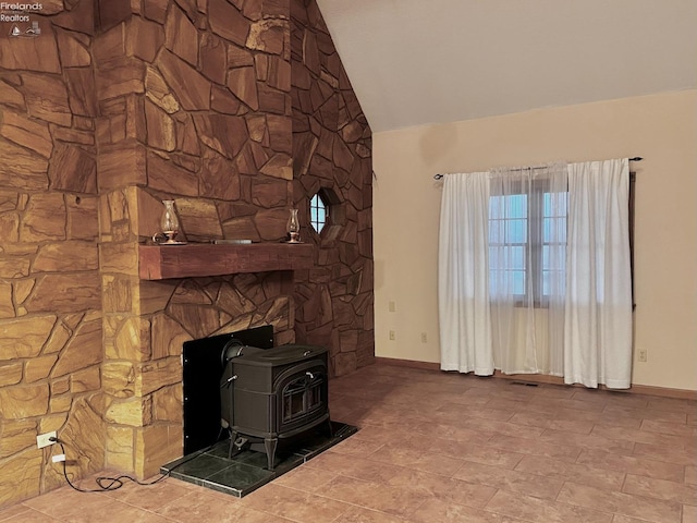 6276 County Road 33, Helena, OH 43435 - unfurnished living room with a wood stove, visible vents, baseboards, and lofted ceiling