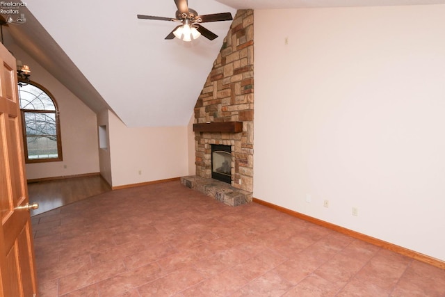 6276 County Road 33, Helena, OH 43435 - unfurnished living room featuring a stone fireplace, baseboards, a ceiling fan, and vaulted ceiling