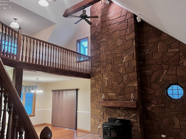 6276 County Road 33, Helena, OH 43435 - unfurnished living room featuring baseboards, a towering ceiling, wood finished floors, and ceiling fan with notable chandelier