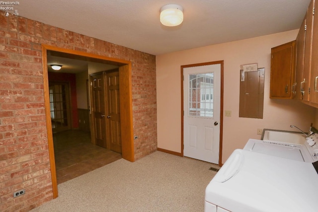 6276 County Road 33, Helena, OH 43435 - washroom with separate washer and dryer, brick wall, electric panel, cabinet space, and light colored carpet