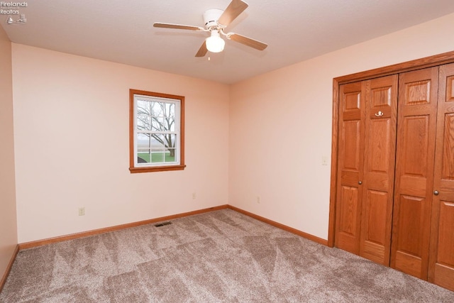 6276 County Road 33, Helena, OH 43435 - unfurnished bedroom with a closet, baseboards, visible vents, ceiling fan, and carpet