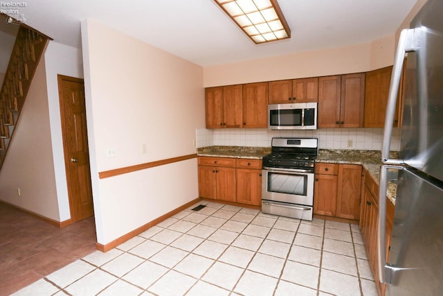 6276 County Road 33, Helena, OH 43435 - kitchen with tasteful backsplash, brown cabinetry, and stainless steel appliances