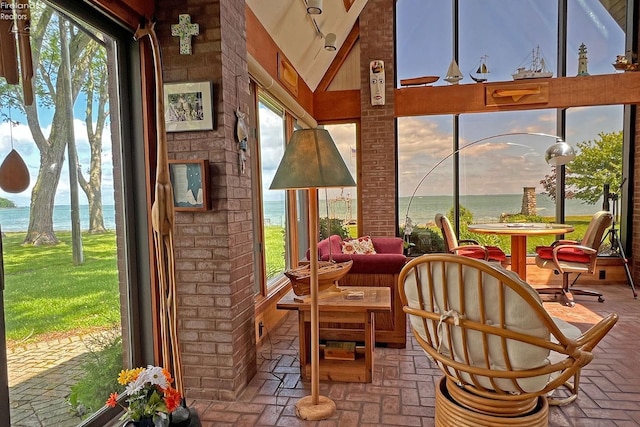 208 Johanna Ln, Kelleys Island, OH 43438 - sunroom with lofted ceiling, a water view, and brick floor