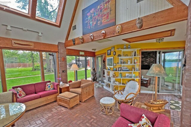 208 Johanna Ln, Kelleys Island, OH 43438 - living area with a high ceiling, brick floor, and visible vents