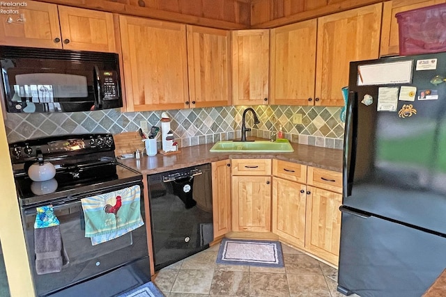 208 Johanna Ln, Kelleys Island, OH 43438 - kitchen with backsplash, black appliances, light brown cabinetry, and a sink
