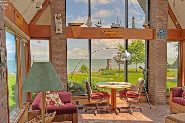 208 Johanna Ln, Kelleys Island, OH 43438 - sunroom / solarium featuring a water view, high vaulted ceiling, and brick floor