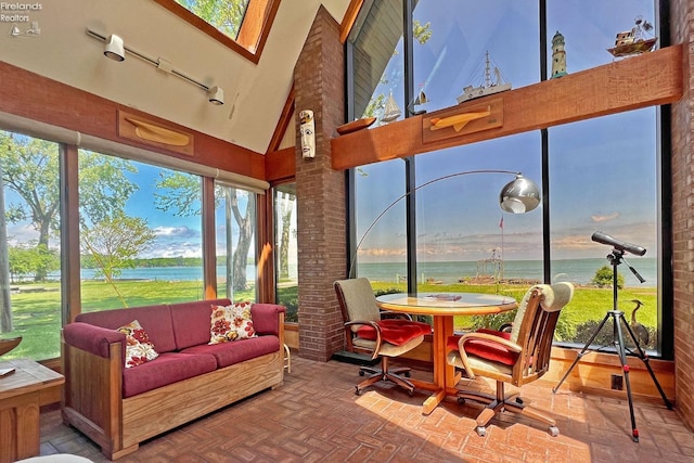 208 Johanna Ln, Kelleys Island, OH 43438 - sunroom / solarium with high vaulted ceiling, brick wall, a water view, and brick floor