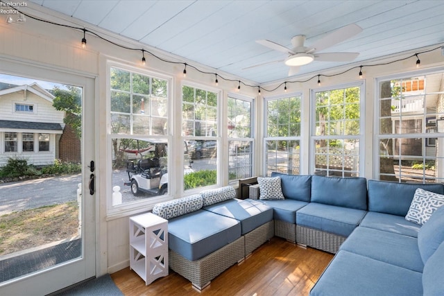 sunroom with an outdoor living space, wooden ceiling, a ceiling fan, and wood finished floors