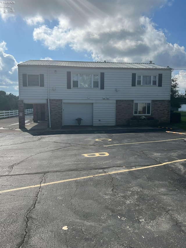 5414 Homegardner, Castalia, OH 44824 - view of building exterior with uncovered parking and fence