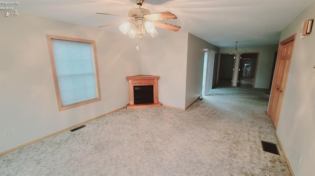 100 Grand Ave, Clyde, OH 43410 - unfurnished living room featuring baseboards, carpet flooring, visible vents, and ceiling fan with notable chandelier