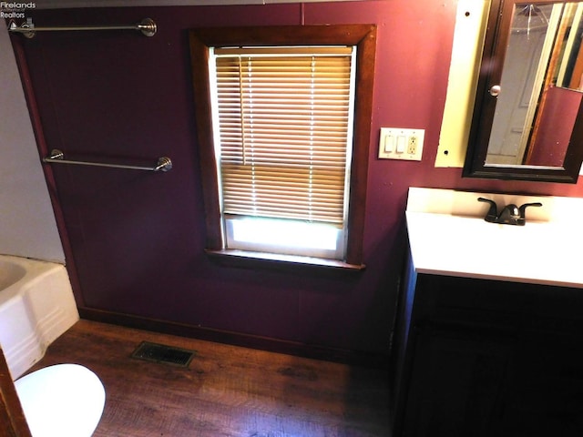 29 Walker St, Tiffin, OH 44883 - full bathroom with wood finished floors, visible vents, toilet, vanity, and a bathtub