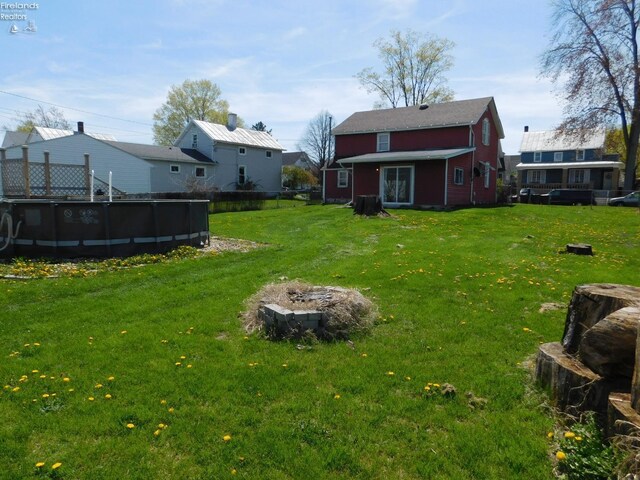 29 Walker St, Tiffin, OH 44883 - view of yard with an outdoor pool and a fire pit
