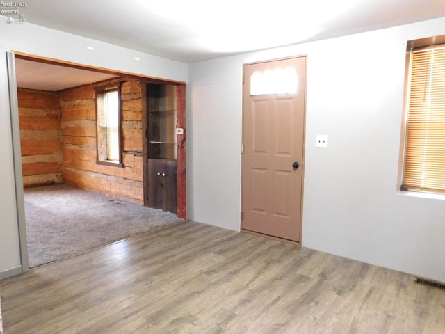 29 Walker St, Tiffin, OH 44883 - empty room with wood walls, wood finished floors, and visible vents