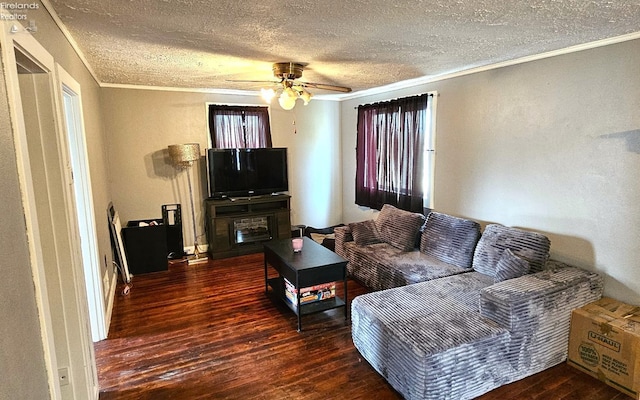 living area with a ceiling fan, a textured ceiling, wood-type flooring, and ornamental molding