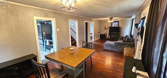 dining area featuring crown molding, a textured ceiling, stairway, and dark wood finished floors