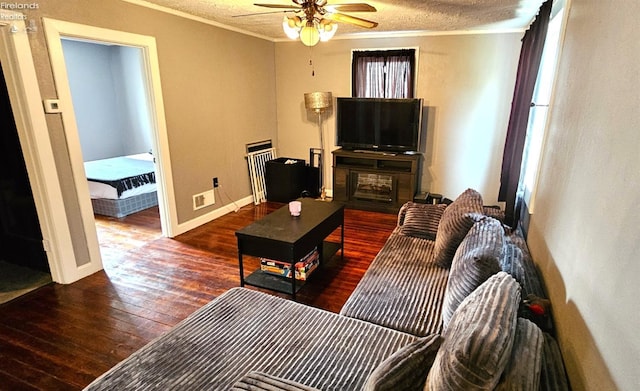 living room with crown molding, ceiling fan, a textured ceiling, and hardwood / wood-style flooring