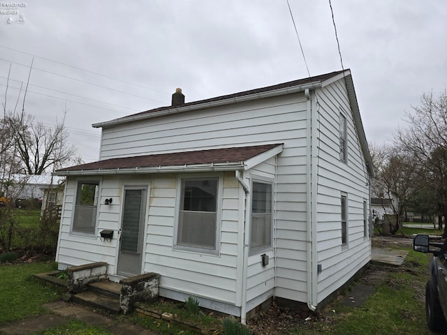 exterior space with entry steps and a chimney