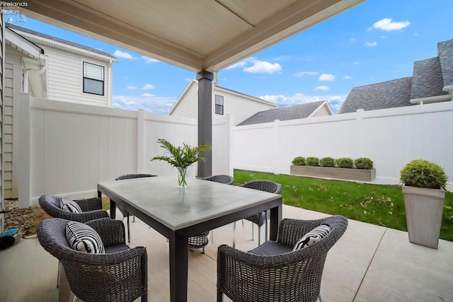view of patio with a fenced backyard and outdoor dining area