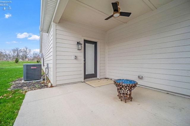 doorway to property featuring a patio area, a ceiling fan, and central air condition unit