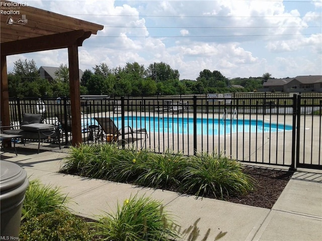 pool with fence, a patio, and a pergola
