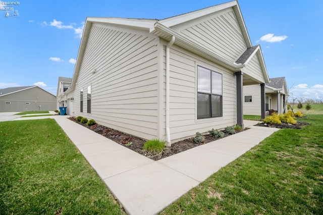 view of side of home with a lawn