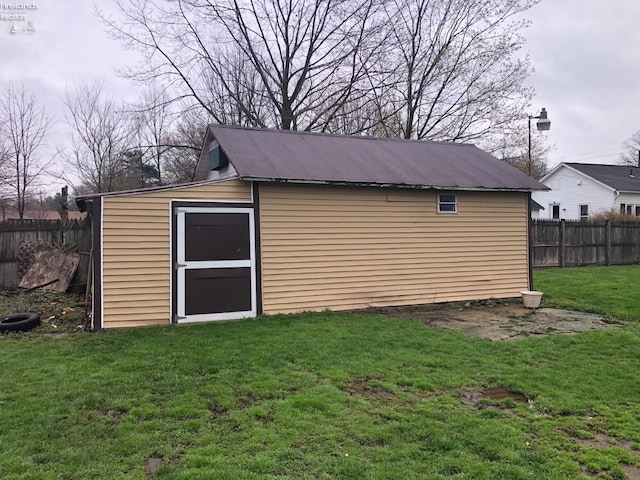 view of outbuilding featuring an outdoor structure and fence