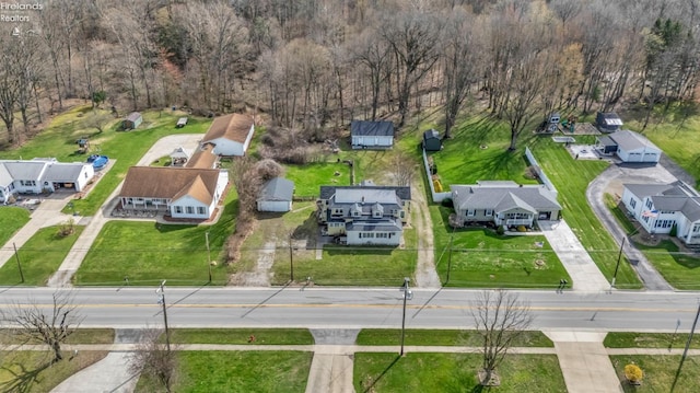 birds eye view of property featuring a view of trees and a residential view