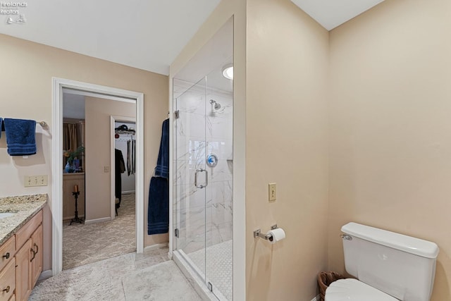 526 Mariner Vlg, Huron, OH 44839 - full bathroom featuring baseboards, toilet, a walk in closet, vanity, and a stall shower