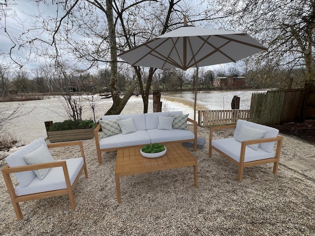 view of patio with a water view and outdoor lounge area