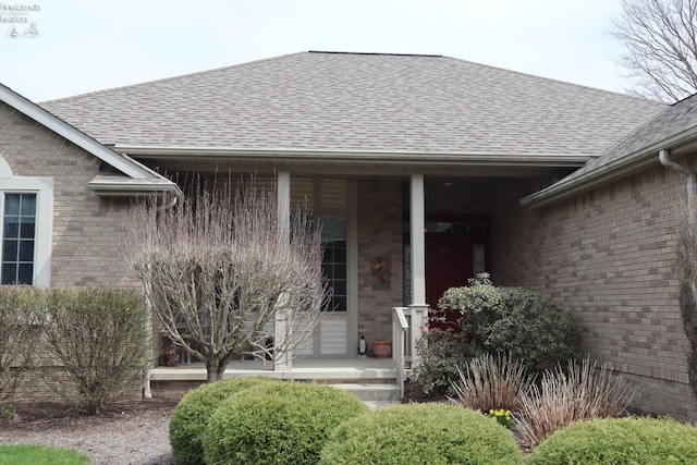79 Ridgeview Cir, Milan, OH 44846 - entrance to property featuring brick siding, a shingled roof, and covered porch