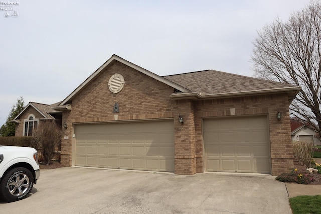 79 Ridgeview Cir, Milan, OH 44846 - view of front of home featuring concrete driveway, brick siding, and an attached garage