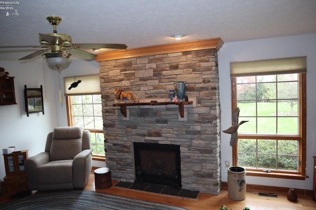 79 Ridgeview Cir, Milan, OH 44846 - living room featuring a fireplace, a ceiling fan, and wood finished floors