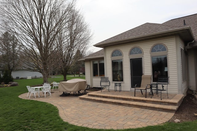 79 Ridgeview Cir, Milan, OH 44846 - back of house featuring a yard, a shingled roof, and a patio