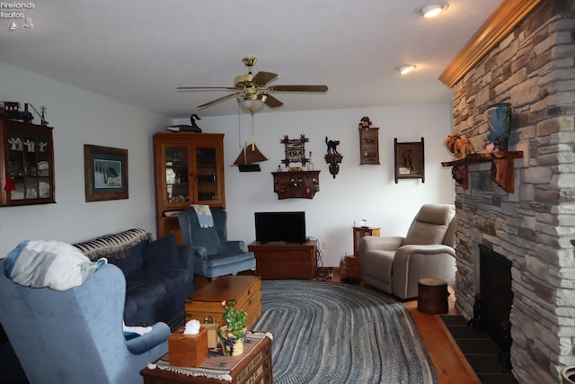 79 Ridgeview Cir, Milan, OH 44846 - living area featuring wood finished floors, a fireplace, and a ceiling fan