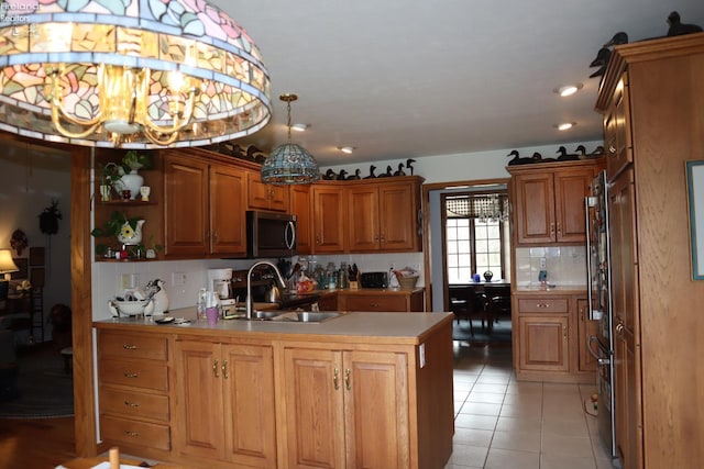 79 Ridgeview Cir, Milan, OH 44846 - kitchen featuring a peninsula, light tile patterned floors, backsplash, stainless steel appliances, and a sink