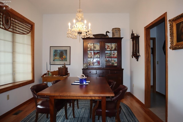 79 Ridgeview Cir, Milan, OH 44846 - dining space with visible vents, baseboards, a notable chandelier, and dark wood-style floors