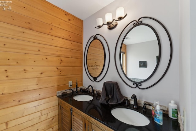 3769 Prospect Rd, New London, OH 44851 - bathroom featuring wood walls, double vanity, and a sink