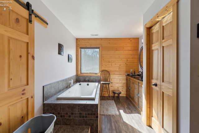 3769 Prospect Rd, New London, OH 44851 - bathroom featuring wood walls, wood finished floors, and tiled tub
