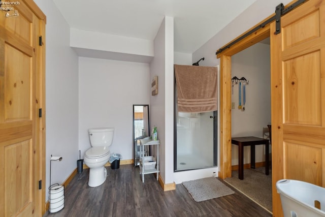 3769 Prospect Rd, New London, OH 44851 - bathroom featuring toilet, a stall shower, wood finished floors, and baseboards