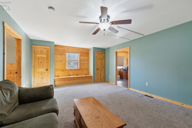 3769 Prospect Rd, New London, OH 44851 - carpeted living room with attic access, ceiling fan, baseboards, and wooden walls