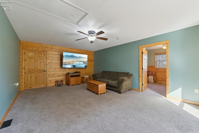 3769 Prospect Rd, New London, OH 44851 - living area with attic access, wood walls, a ceiling fan, and visible vents